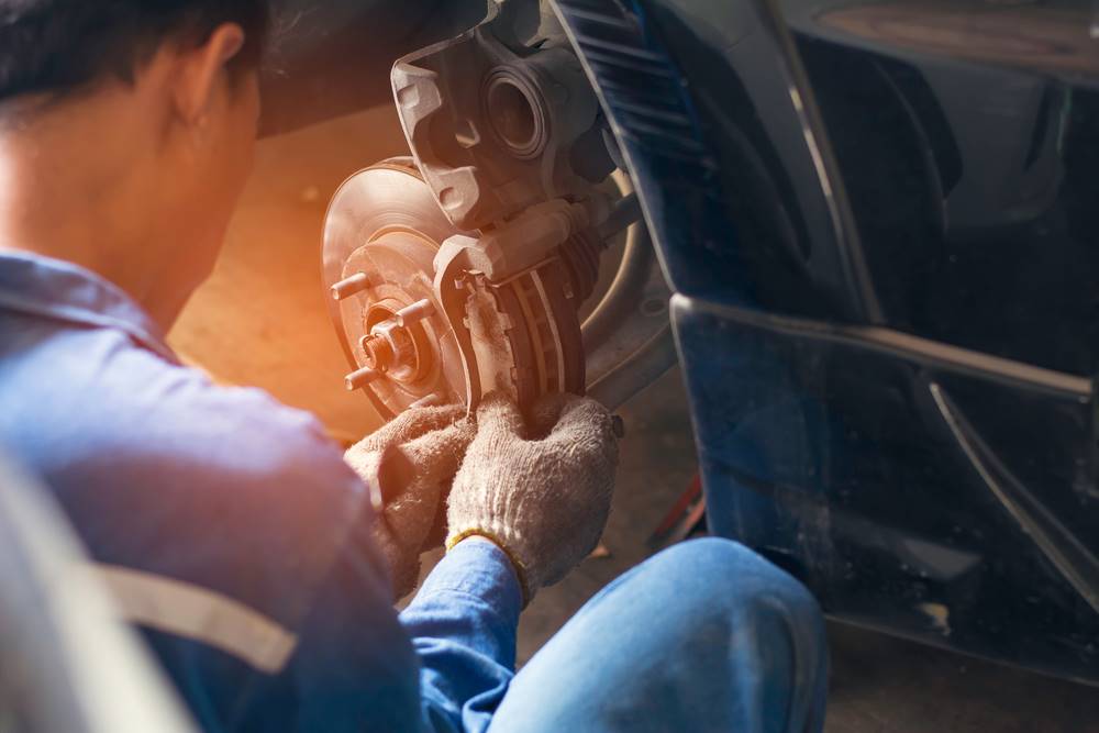 man changing brakes