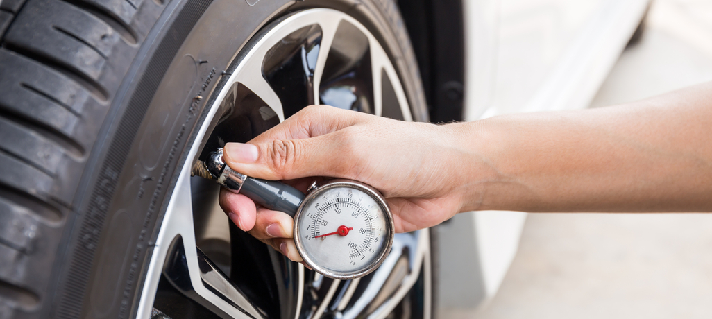 person checking tire pressure