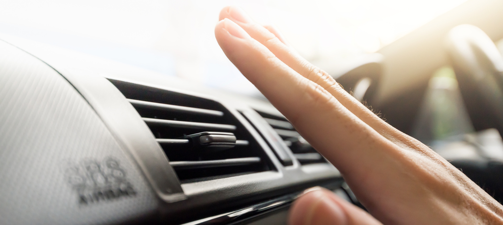 person feeling the air in the car