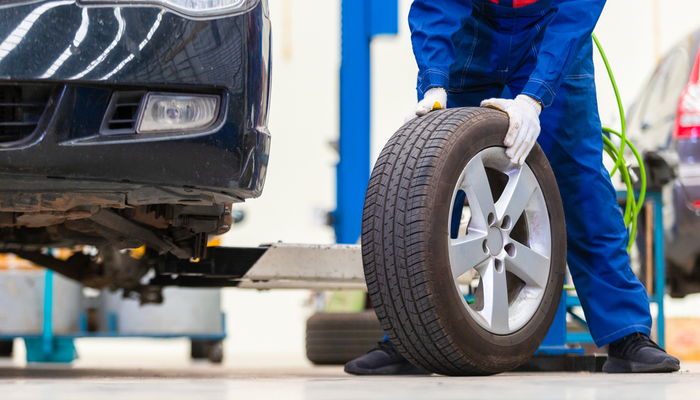 man changing tire